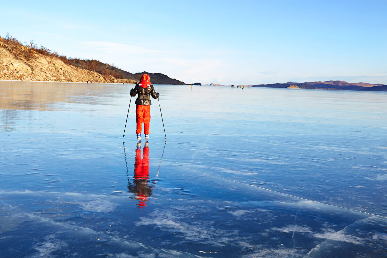Девушка на льду Байкала на коньках